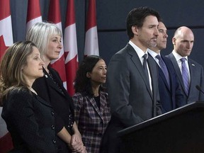 Prime Minister Justin Trudeau listens to a question with Deputy Prime Minister and Minister of Intergovernmental Affairs Chrystia Freeland, Minister of Health Patty Hajdu, Chief Medical Officer Theresa Tam, Minister of Finance Bill Morneau and President of the Treasury Board Jean-Yves Duclos during a news conference on the coronavirus situation, in Ottawa on March 11, 2020.