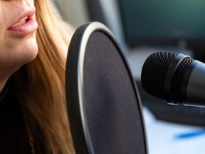 A journalist talks into a microphone on March 12, 2019 in Washington. - Tapping fingernails triggering goosebumps, whispers sending shivers down the spine: the brain-tingling world of ASMR has the internet clamoring for sounds that feel good. The auditory-sensory phenomenon sees people experience waves of calm and pleasurable quivers of the mind often referred to as "brain orgasms" -- and it's emerging from the depths of the web into the pop culture mainstream as a means to relax. ASMR, short for autonomous sensory meridian response, has become a full-fledged internet sensation, with YouTube creators notching millions of views for clips featuring stimuli -- low whispers into a microphone, long nails tapping, noodle slurping -- to set off a prickle at the back of the neck. (Photo by Eric BARADAT / AFP)        (Photo credit should read ERIC BARADAT/AFP/Getty Images)