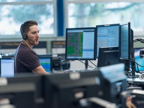 Call-taker at work in the main E-Comm dispatch centre in Vancouver. E-Comm personnel are the first point of contact for people dialing 911, handing off calls the appropriate police, fire and ambulance dispatchers.