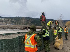 Members of the Canadian Armed Forces continue Hesco container construction along a section of the Coldwater River in Merritt on Dec. 1, 2021.
