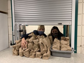 Christine Love (left) and Michelle Douglas with brown-bag lunches delivered to Vernon schools coping with a rise in children attending school without food for the day.