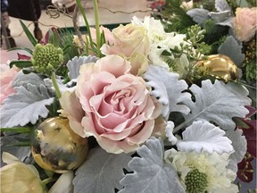 Cut stems of roses, eucalyptus and dusty miller create a charming centrepiece.