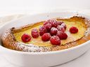A deflated Dutch baby in the pan, it has been baked, topped with berries and icing sugar, waiting to be sliced.  Pictured: Karen Gordon.