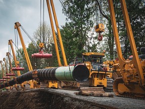 The changes announced in late February focus on the impacts of marine shipping and potential oil spills from ships related to the pipeline project. Laying pipe for the Trans Mountain expansion project near Popukum in the Fraser Valley in May 2021.