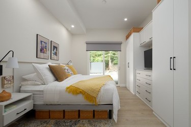Built-in headboards and wall-mounted nightstands save precious space in the bedroom, while a wall of cabinetry designed by California Closets seamlessly stores the couples' belongings.