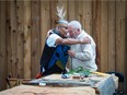 Squamish Nation carver Xwalacktun hugs an emotional Bill Tate, 93. They met in August when the artist was preparing a house post for St. Andrew’s Wesley United Church, which would embrace a plaque devoted to Tate’s grandfather, a residential school founder.