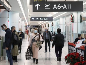 United States-bound passengers walk in Toronto Pearson Airport's Terminal 3, days before new COVID-19 testing protocols to enter the U.S. come into effect, in Toronto, Dec. 3, 2021.