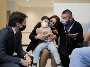 Prime Minister Justin Trudeau visits a COVID-19 vaccination clinic for children at Scarborough Health Network's Centenary Hospital in Toronto, Dec. 10, 2021.