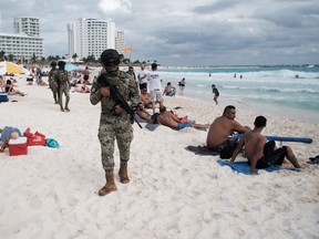 Members of the Navy patrol a beach resort in Cancun, part of a program created by the provincial government of Quintana Roo, Mexico.