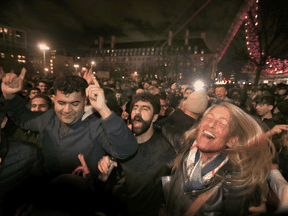 A large crowd party and celebrate New Year's by the London Eye on December 31, 2021 in London, England.