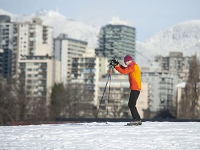 People enjoy the winter conditions at Vanier Park in Vancouver on Tuesday. Cold and snow continue through the week.