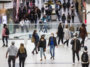 Shoppers stroll through the Eaton Centre in downtown in Toronto, Ont. on Sunday, Oct. 17, 2021.