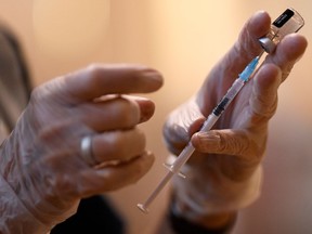 A booster dose of the Pfizer Covid-19 vaccine is drawn up in a vaccination clinic set up at St Columba's Church in Sheffield on December 15, 2021 as the UK steps up the country's booster drive to fight a "tidal wave" of Omicron. - The country's medical advisers have raised the Covid Alert Level due to a "rapid increase" in infection from the variant.
