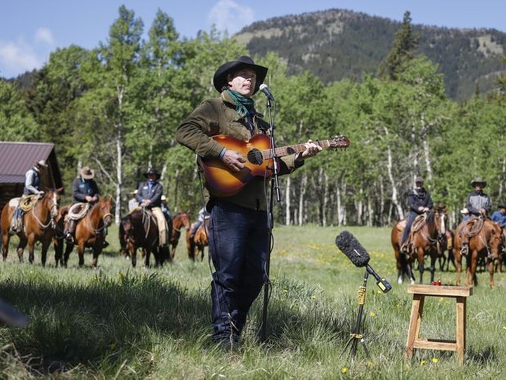  Singer Corb Lund sings on land proposed for coal mine development in the eastern slopes of the Livingstone range south west of Longview, Alta.