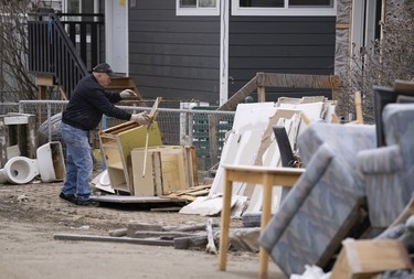 CP-Web. A man throws out the contents to the inside of a home that was flooded downtown Princeton, B.C., Friday, Dec. 3, 2021. Princeton, like many parts of the province, was hit with heavy floods and mudslides over the past couple of weeks causing major devastation.