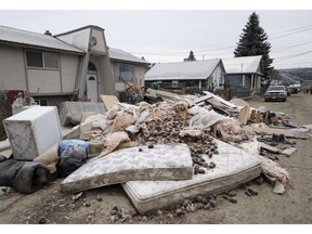 The contents to the insides of homes that were flooded are pictured on the street in downtown Princeton, B.C., Friday, Dec. 3, 2021.