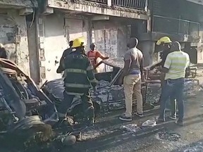 People stand at the site of an explosion in Cap-Haitien, Haiti December 14, 2021, in this still image obtained from Reuters TV footage.