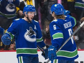 Vancouver Canucks forward J.T. Miller (9) and forward Brock Boeser (6) celebrate Miller's goal against the Los Angeles Kings in the third period at Rogers Arena. Vancouver won 4-0.