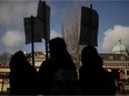Wet'suwet'en supporters and Coastal GasLink opponents are silhouetted as they protest 20 government buildings throughout Victoria, Friday, Feb. 14, 2020.