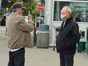 Ivan Scott of Keep Surrey RCMP and Surrey Mayor Doug McCallum, right, have a lively conversation in the parking lot of a grocery store in South Surrey on Saturday.