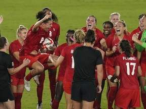 Canada players, including Christine Sinclair, celebrate their win against Sweden during the women's soccer gold medal game at the Tokyo Olympics in Yokohama, Japan on Friday, August 6, 2021.