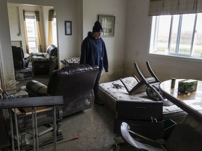 Cassie Courtemanche surveys the damage to her mother's home on the Sumas Prairie on Tuesday.