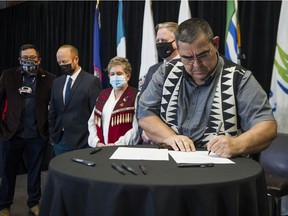 Musqueam Chief Wayne Sparrow signs an agreement with other First Nations representatives and the mayors of Vancouver and Whistler to study a bid to host the 2030 Winter Olympic Games.