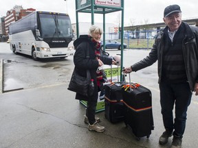 Don and Peggy Cunningham at the Pacific Central Station in Vancouver on Wednesday. The pair had just disembarked from an Ebus from Kelowna, one of the first buses to traverse the Coquihalla since it reopened to commercial traffic on Tuesday.