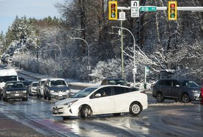 A driver makes a U-turn as cars pass through the intersection at 88th Avenue and King George Boulevard in Surrey on Thursday.