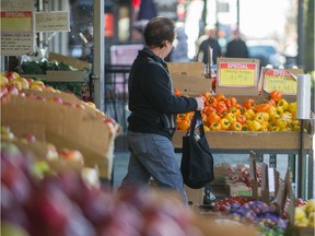 People shop for groceries on Commercial Drive in Vancouver.