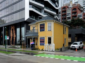 Historic Leslie House, known as the 'Little Yellow House', is has been restored at its location on Pacific Street in Vancouver.