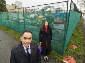 St. Augustine principal Michael Yaptinchay and parent Cristina Valentinuzzi are pictured at the Skytrain station under construction near St. Augustine School in Vancouver, BC. Dec. 14, 2021.