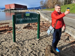 A sign declaring "Barge Chilling Beach" was installed at Sunset Beach this week, near the site of an infamous barge that broke free from its moorings and was grounded during a Nov. 15 storm surge.