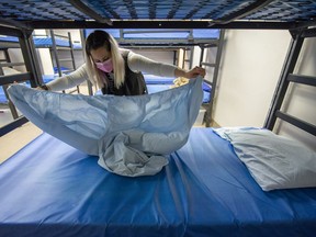 Nicole Mucci of the Union Gospel Mission helps make beds at the mission shelter in Vancouver on Tuesday.