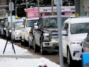 People wait for drive-through COVID-19 testing in North Vancouver on Monday. Some testing sites in the Lower Mainland are closing or reducing capacity due to extreme cold.