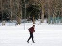 A jogger endures the cold on a run in Burnaby on Monday. Cold temperatures and even colder wind chills continue today. 