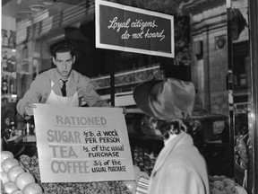 'Loyal citizens do not hoard,' says the sign in a store window in 1942 after rationing began. Meat was added in 1943.