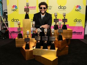 The Weeknd, winner of the Top Artist Award, Top Male Artist Award, Top Hot 100 Artist Award, Top Radio Songs Artist Award, Top R&B Artist Award, Top R&B Album Award, Top Billboard 200 Album Award, Top Hot 100 Song Presented by Rockstar Award, Top Radio Song Award, and Top R&B Song Award poses backstage for the 2021 Billboard Music Awards, broadcast on May 23, 2021 at Microsoft Theater in Los Angeles, California.