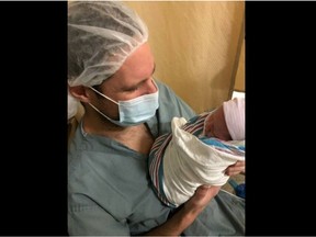 Proud father Ishmael Grimwood at Victoria General Hospital holds his boy, the first baby born on New Years in British Columbia.
