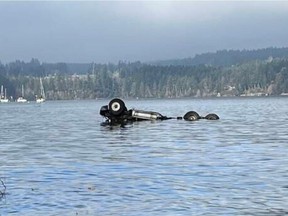 A dump truck landed upside down in the water off Mill Bay after the driver lost control on Frayne Road on Wednesday, Jan. 26, 2022.