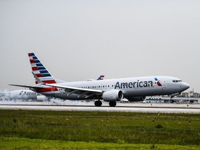 An American Airlines plane lands at the Miami International Airport in July 2021. A pilot decided to turn around an hour after takeoff on flight from Miami to London on Wednesday, after a woman refused to wear a mask on the plane.