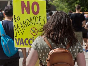 People protest the implementation of vaccine passports by Ontario, in Toronto City on Sept. 1, 2021.