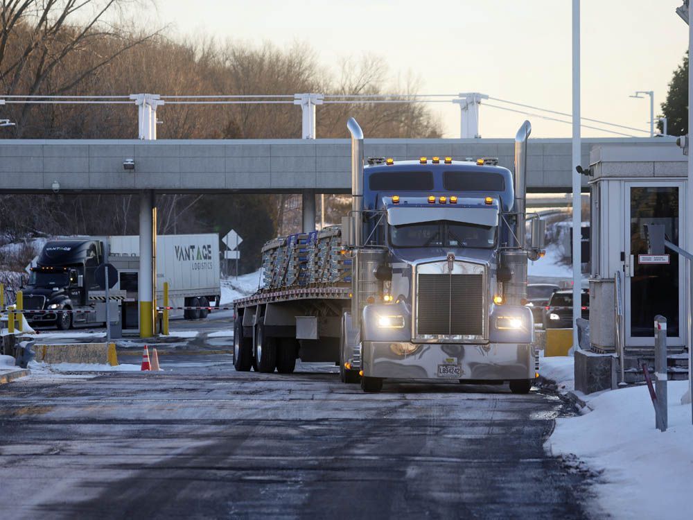 Trucks head into Canada from the U.S. at the Highgate Springs-St.Armand/Philipsburg Border Crossing in Saint-Armand, Quebec, Canada, on Friday, Jan. 14, 2021. A group of Canadian truckers are organizing a convey to drive to Ottawa, from as far as B.C., to protest the federal vaccine mandate.