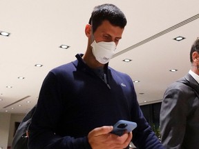 Serbian tennis player Novak Djokovic walks in Melbourne Airport before boarding a flight, after the Federal Court upheld a government decision to cancel his visa to play in the Australian Open, in Melbourne, Australia, January 16, 2022