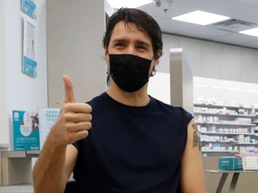 Canada's Prime Minister Justin Trudeau reacts after receiving his booster injection of a coronavirus disease (COVID-19) vaccine at a pharmacy in Ottawa, Ontario, Canada January 4, 2022.