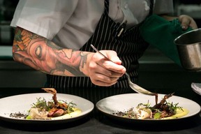 A chef works his magic on a dish at Dine Out Vancouver.