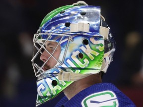 Vancouver Canucks goalie Spencer Martin looks on before an NHL hockey game against the Florida Panthers in Vancouver, on Jan. 21 2022.