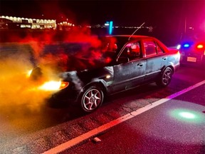 Abbotsford police tweeted out this photo of a 2003 Mazda Protege with a blown engine after the young driver was pulled over for going 200 km/h on Highway 1.