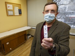 Dr. Brian Conway holds a rapid test in a file photo.