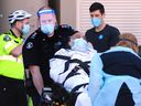  First responders in the Downtown Eastside work on a patient during the second year of the COVID-19 pandemin Vancouver, BC., on April 19, 2021.  